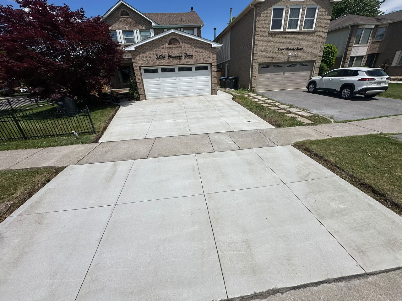 Finished broom-finish double driveway and walkway across a full house frontage