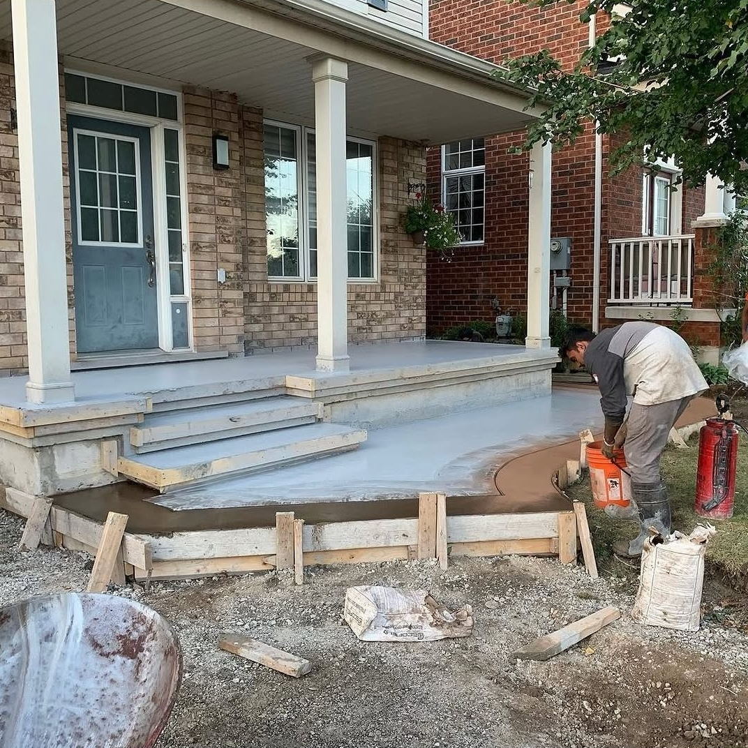 Porch slab and foundation being poured and floated in Cambridge