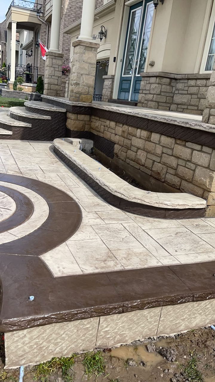 Stamped patio with a circular medallion and a curved stone retaining wall